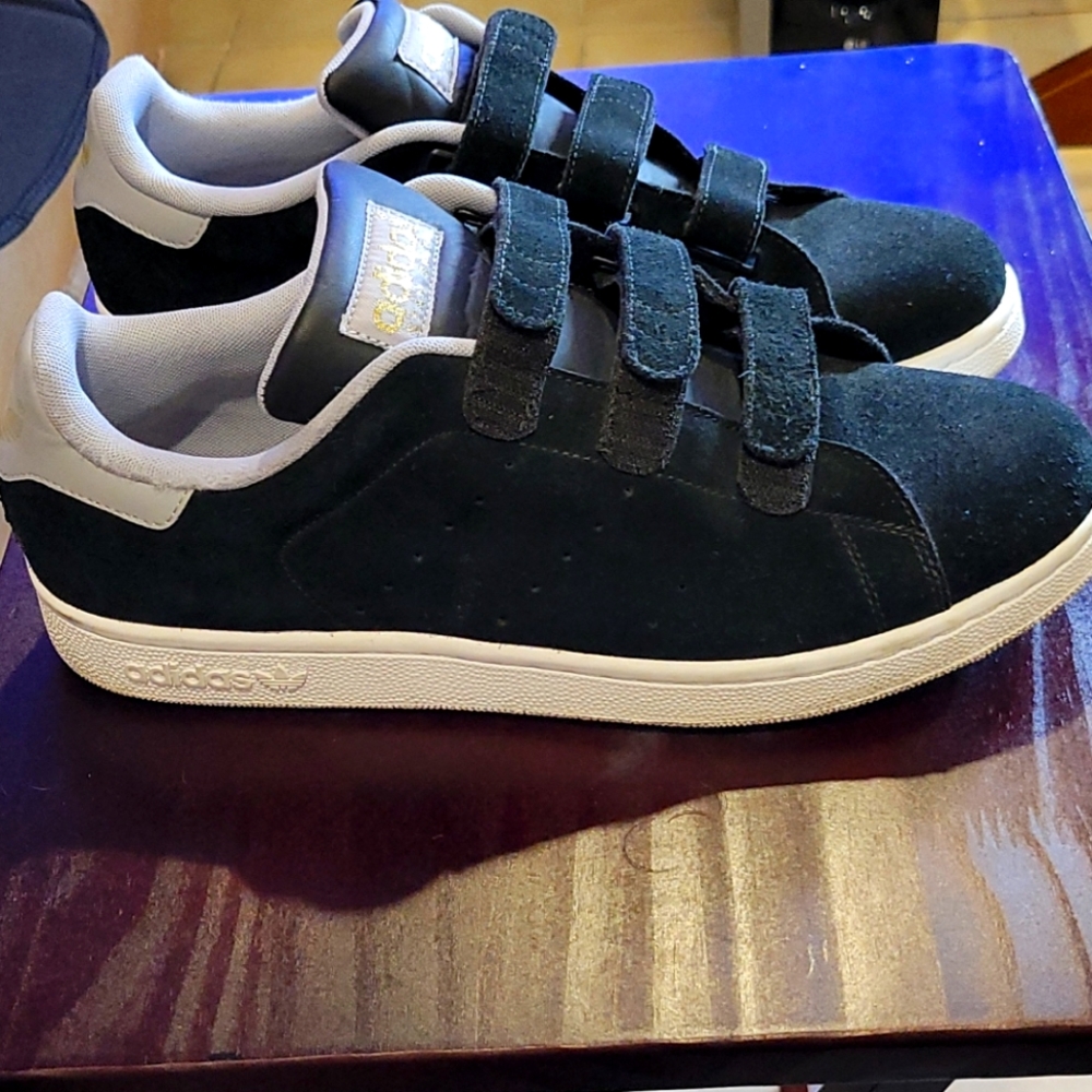 Black and white suede Adidas.